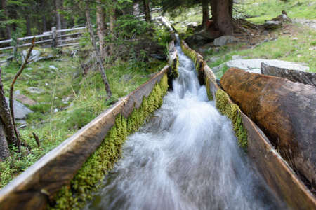 Water canalization made of wood built to irrigate the fields (called roggia)のeditorial素材
