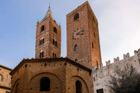 The belfry of the Cathedral and the Clock Tower, medieval landmarks in the old town of the ligurian village of Albengaの写真素材