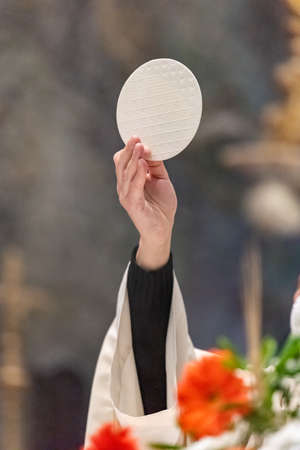 The elevation of the Sacramental Bread during the catholic liturgyの写真素材