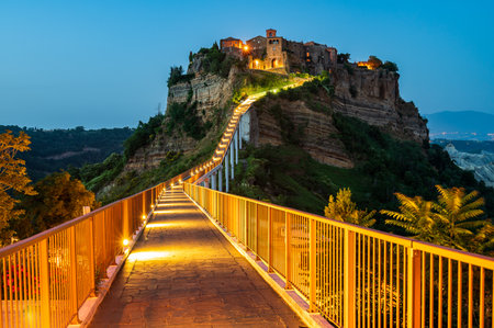 The ancient village of Civita di Bagnoregio, also called the diying city, in the region of Tuscia, Italy, at the blue hourの写真素材