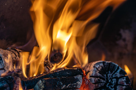 Red, orange and yellow flames from firewood in a ovenの写真素材