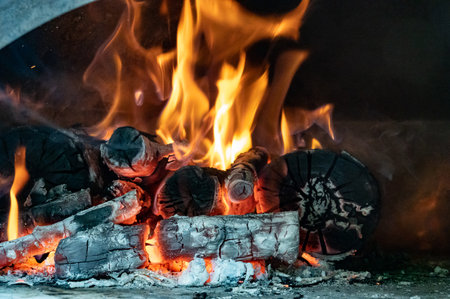 Red, orange and yellow flames from firewood in a ovenの写真素材