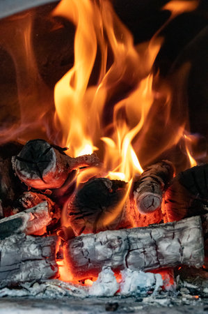 Red, orange and yellow flames from firewood in a ovenの写真素材