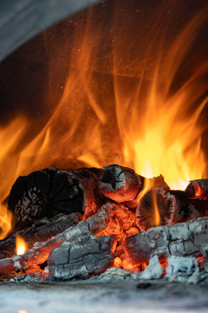 Red, orange and yellow flames from firewood in a ovenの写真素材