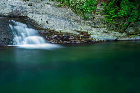 Long exposure of the little waterfalls of a river in Calvari, Italy