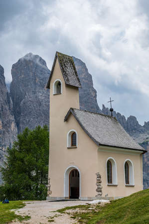 On the Gardena Pass there is this little white church facing the Sella Group in the heart of Dolomitesの写真素材
