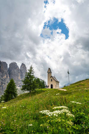 On the Gardena Pass there is this little white church facing the Sella Group in the heart of Dolomitesの写真素材