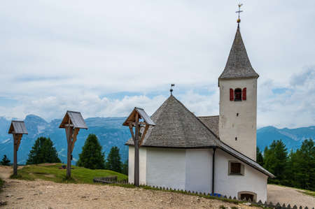 The sanctuary of  Santa Croce under Sas dla Crusc, in the Dolomites of Val Badia, Italyの写真素材