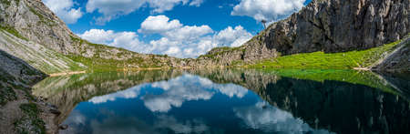 Reflection of the sky in the alpine Lake of Boe, near Corvara, in the Dolomites of Val Badiaの写真素材