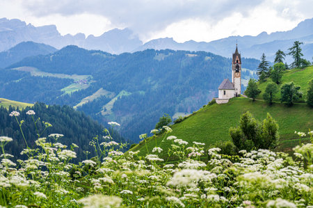The ancient church of Saint Barbara on a scenic position in La Val, Val Badia, in the heart of Dolomitesの写真素材