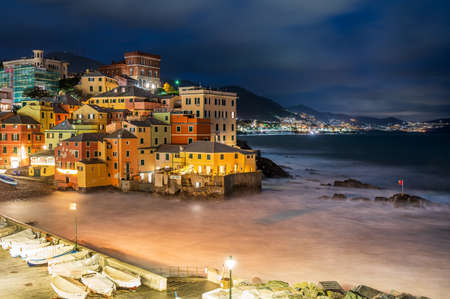 The fishing village of Boccadasse in the center of Genoa, Italy, illuminated by nightの写真素材