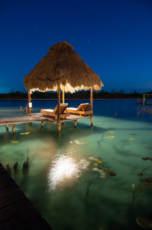 Wonderful lagoon with turquoise water in Bacalar, Mexico at the blue hourの写真素材