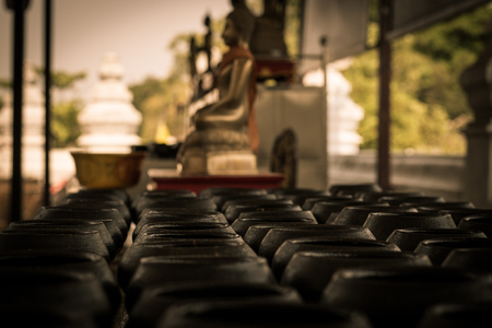 row of monk's alms bowl . Wat Mong khon Bophit temple in Ayutthaya Thailand . traveller can donate a coin for traditional . many space for background .の写真素材