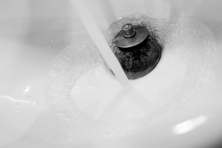 white clean ceramic water sink in toilet with swirl water . hand wash bowl for healthの写真素材