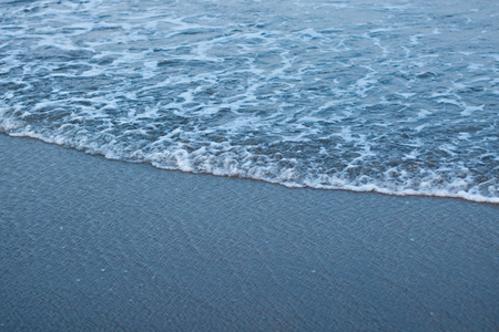 blue soft wave with clean ocean . sun light on sea . travel to the beach on summer holiday .の写真素材
