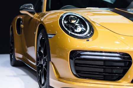 Nonthaburi , Thailand - April 7, 2018: front side view with light bulb led for car headlights . Porsche 911 GT3 color yellow at motor show .のeditorial素材