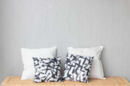 blurred interior design with pillows and wooden table in living room . loft or minimal style .の写真素材