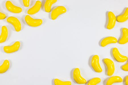 yellow color sweet banana shape . sugar yummy candy on white background .の写真素材