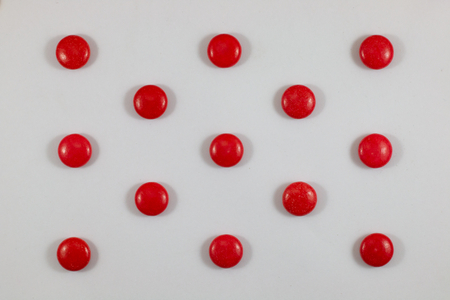 red color sweet circle shape . sugar yummy balls candy on white background .