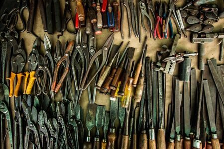Bangkok, Thailand - Jul 14, 2018 : different rusty sharp tools on brown leather background . old vintage weapon for cutting instrument collections at workshop .のeditorial素材