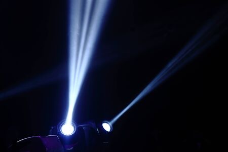 projector spotlights in smoke texture . lights beam for showing presentation . production and director multimedia background .の写真素材