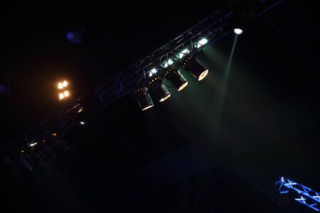 projector stage lighting . equipment for show presentation in night party . spotlight on smoke texture .の写真素材
