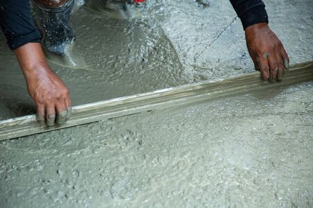 cement building worker with trowel at construction site .