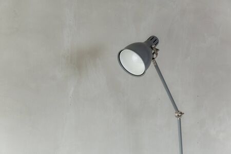 gray electricity lamp post and bare cement wall near the window , minimal background .の写真素材
