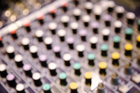 Blurred sound mixing control , close up texture and pattern of music panel electric instrument . entertainment professional machine set .の写真素材