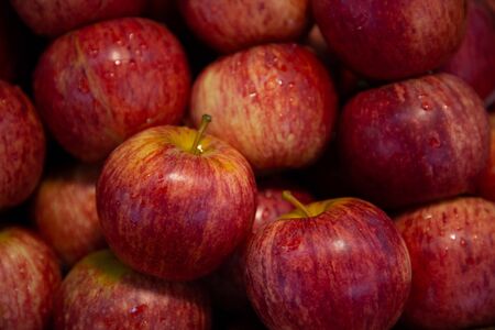 heap of red apples fruits in market .