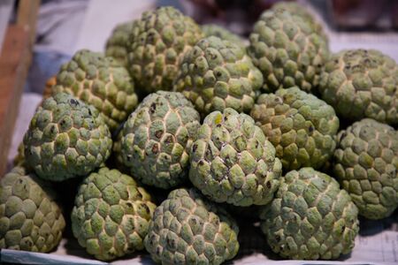 heap of apple custard or suger apple fruits in market .
