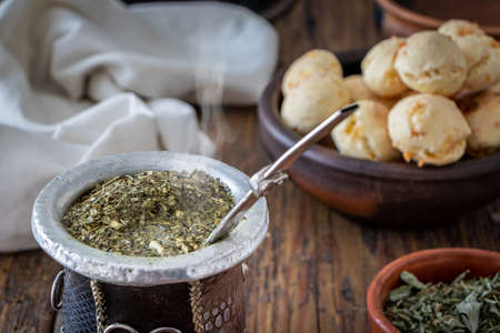 Argentine mate with Chipa on a wooden table