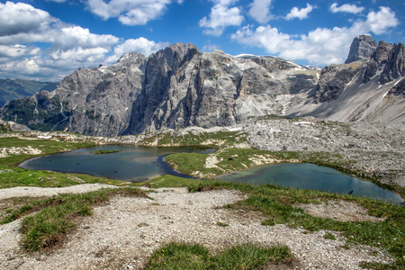 The lake along the walk Tre Cime di Laveredo trail, three of the most famous peaks of the Dolomites, in the Sesto Dolomites, Italy, Europeの写真素材