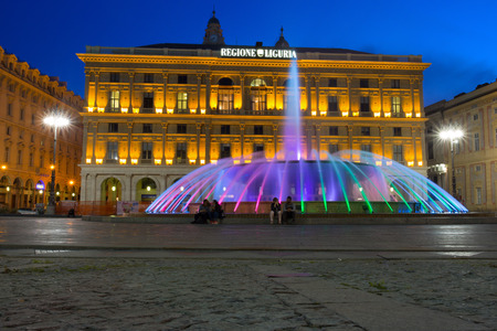GENOA (GENOVA), ITALY, APRIL 16, 2018 - View of the colorful fountain and Palace of the Liguria region of De Ferrari Square by night in Genoa, the heart of the city, Italy.のeditorial素材