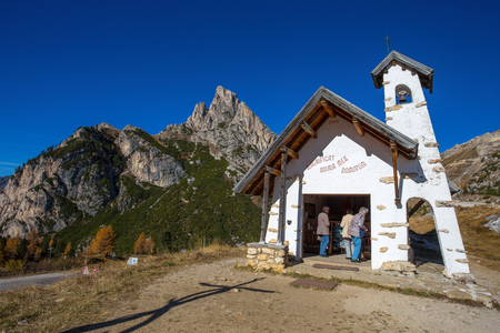 FALZAREGO PASS, ITALY, OCTOBER 19, 2017 - Chapel with Sass de Stria mountain in background on Falzarego Pass (Passo di Falzarego) at sunny autumn day. Dolomites Alps, Italy.のeditorial素材