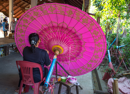 CHIANG MAI, THAILAND, FEBRUARY, 19, 2017 - Bo Sang village, handmade umbrellas and parasols, unidentified woman at work at the umbrella making centre Ban Bo Sang, Chiang Mai, Thailand.のeditorial素材