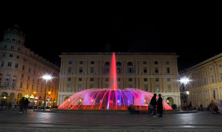 GENOA (GENOVA), ITALY, NOVEMBER 24, 2018 - View of the colorful fountain of De Ferrari Square by night in Genoa, the heart of the city, Italy.のeditorial素材