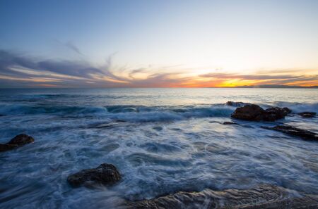 Sunset with the rough sea in autumntime, Italyの写真素材