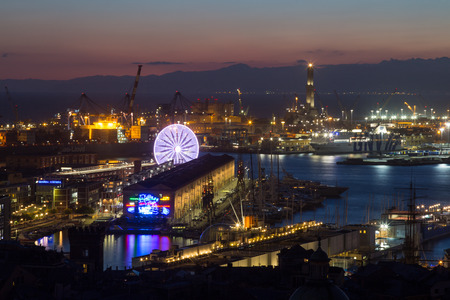GENOA, ITALY, NOVEMBER  5, 2019 - Aerial view of Genoa, Italy at night, the harbor with the Lanterna, the lighthouse,  symbol of the city, and the ferris wheel, Italy.のeditorial素材