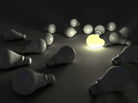 lit light bulb among unlit onesの写真素材