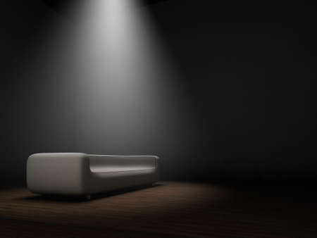 Couch in dark room with spotlight from top