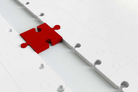 Red puzzle pease as a bridge to white partsの写真素材