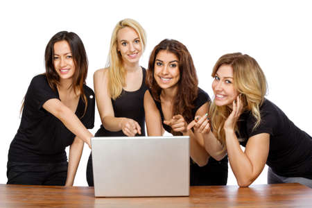 Group of girls pointing at a laptop with white backgroundの写真素材