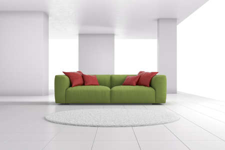 Green sofa in bright room with red cushionsの写真素材