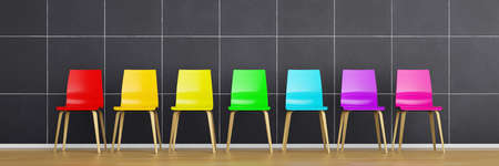 Row of chairs with rainbow colors in front of a black wall 3d renderingの写真素材