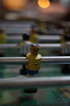 a small man with a wooden table soccer gameの写真素材