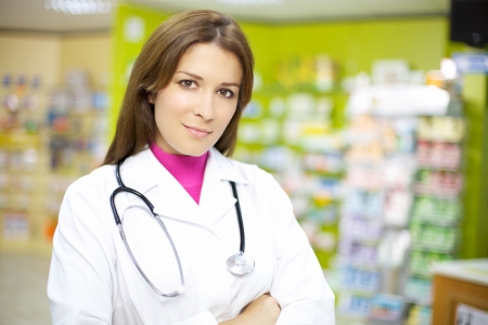 Attractive female doctor working in pharmacy happyの写真素材