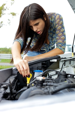 Car with broken engine with beautiful female modelの写真素材