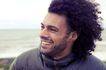 Happy man smiling with long funky hairの写真素材