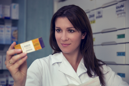 Good looking pharmacist in pharmacyの写真素材